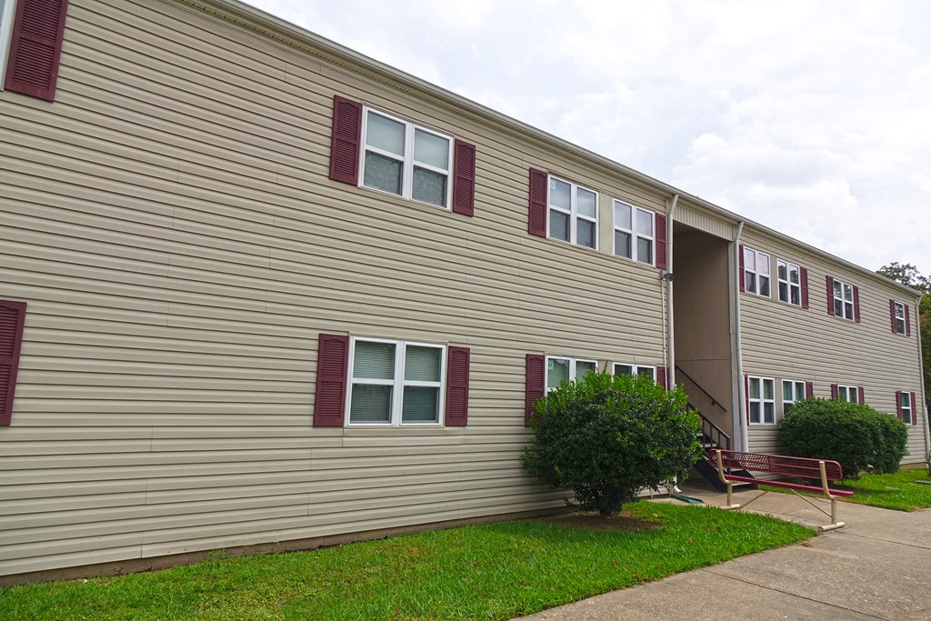 the side of a building with a red bench