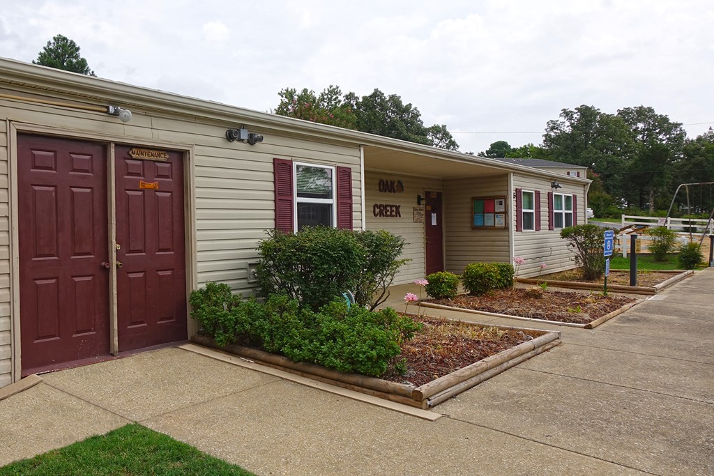 a building with two doors and a sidewalk in front of it