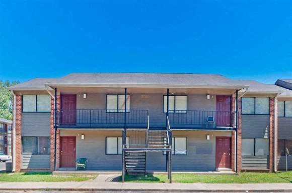 an apartment building with a staircase in front of it
