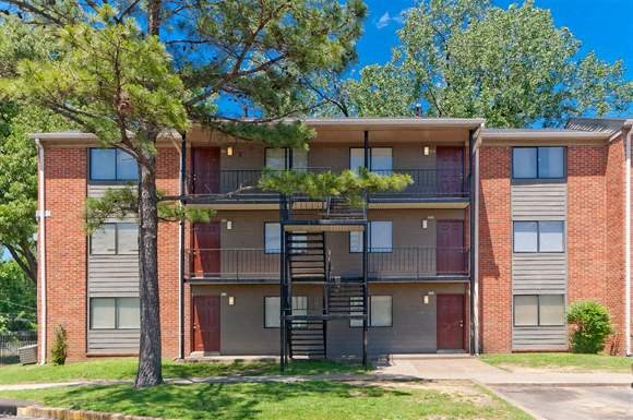 the front of an apartment building with a spiral staircase