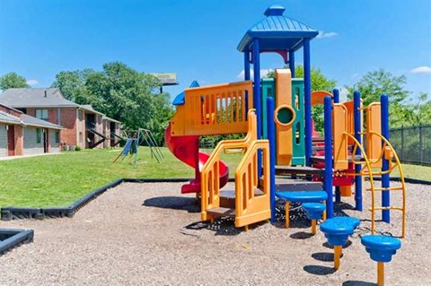 a colorful playground on a sunny day in a park