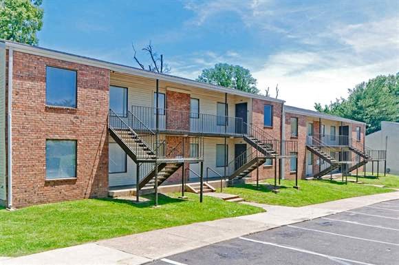 a row of brick apartment buildings with stairs