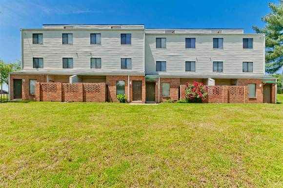 a large building with a green lawn in front of it