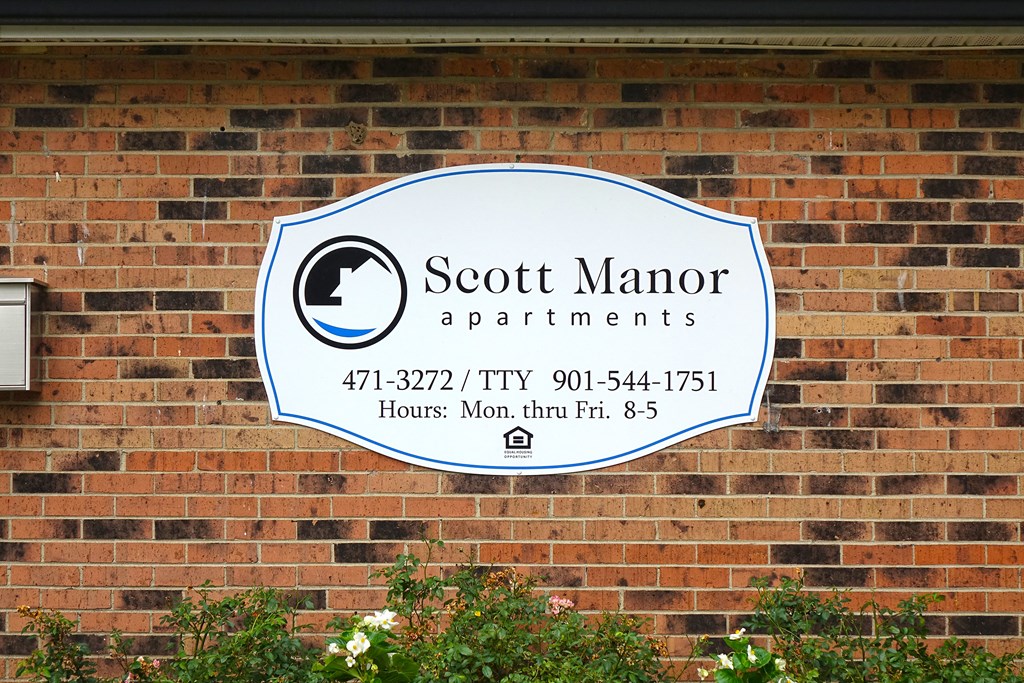 a sign on the side of a brick building