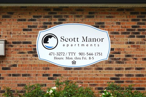 a sign on the side of a brick building