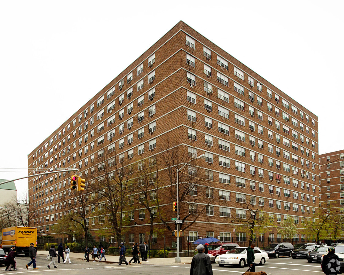a tall building with people crossing the street in front of it