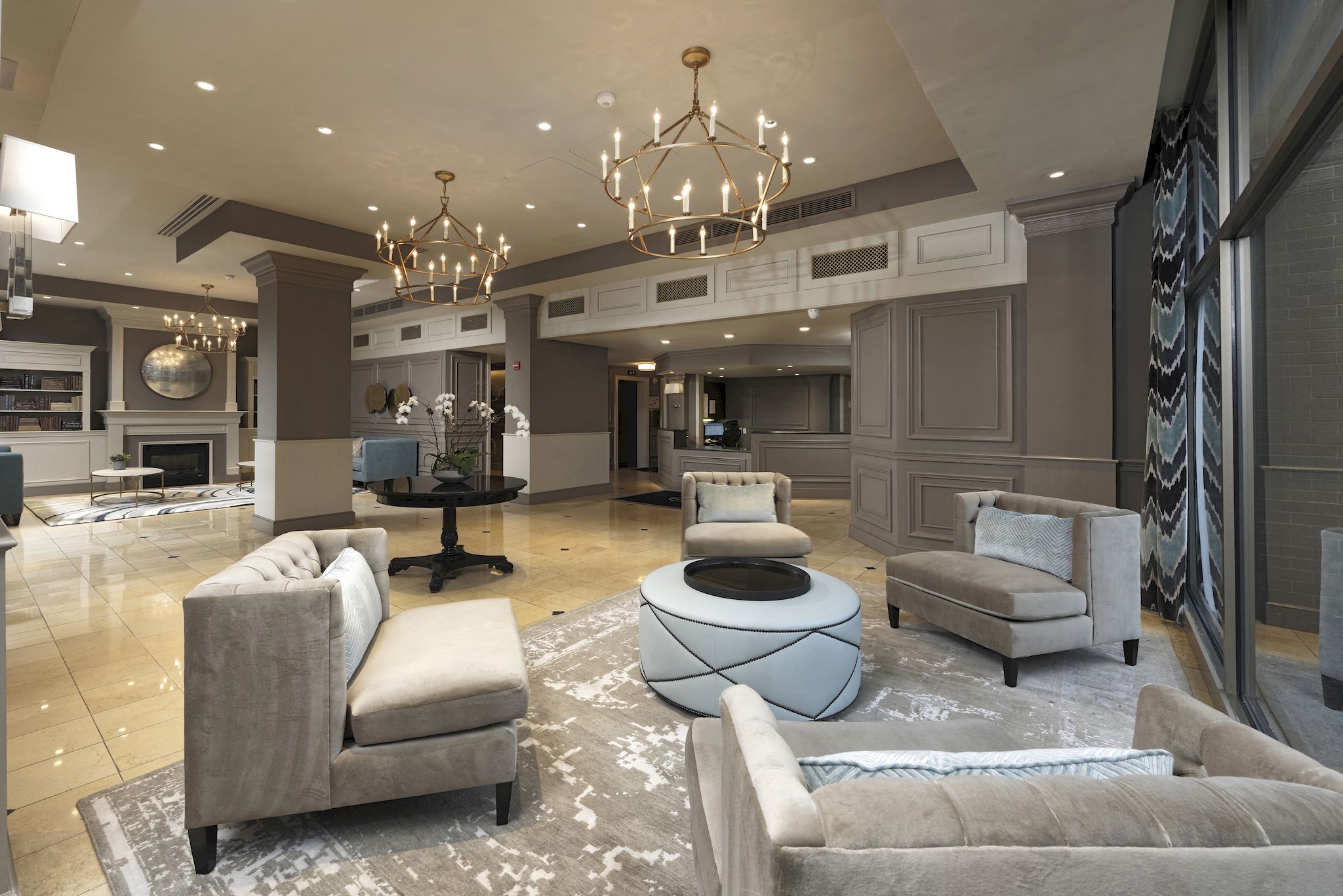 a large living room with couches and chairs and a coffee table