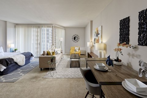 a living room and dining room with a couch and a table