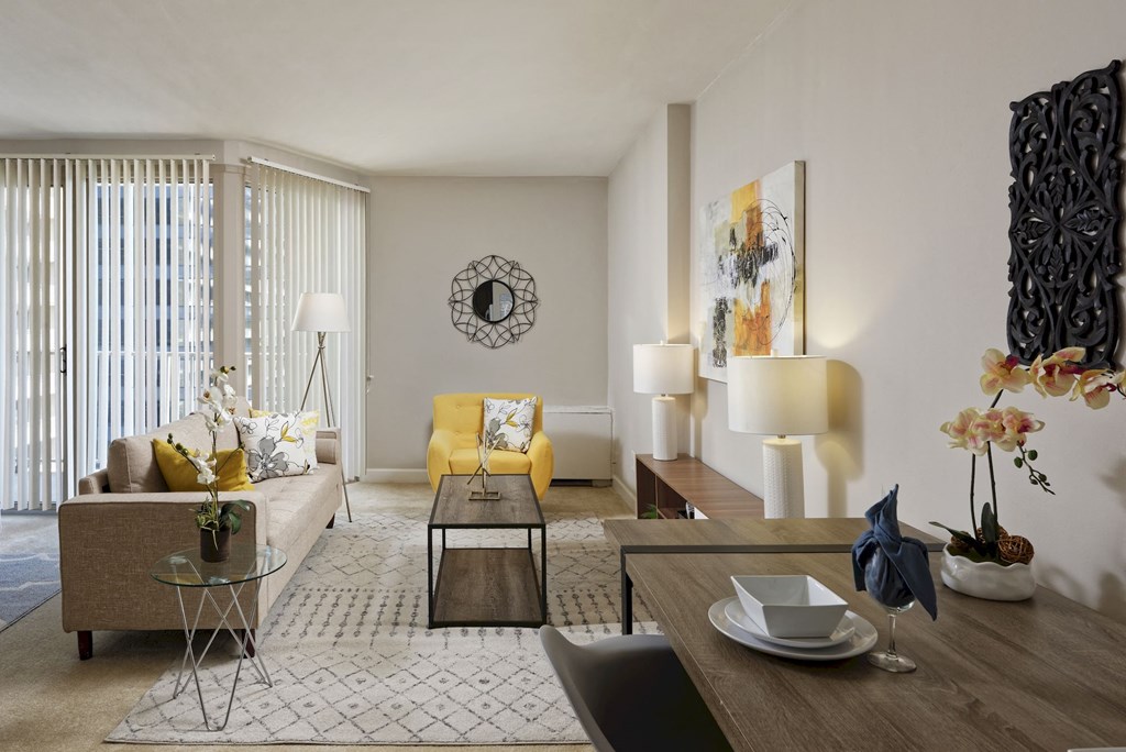 a living room with a yellow couch and a table