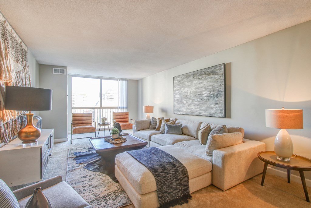 the living room of an apartment with a couch and a table