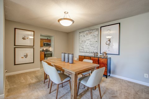 a dining room with a wooden table and chairs