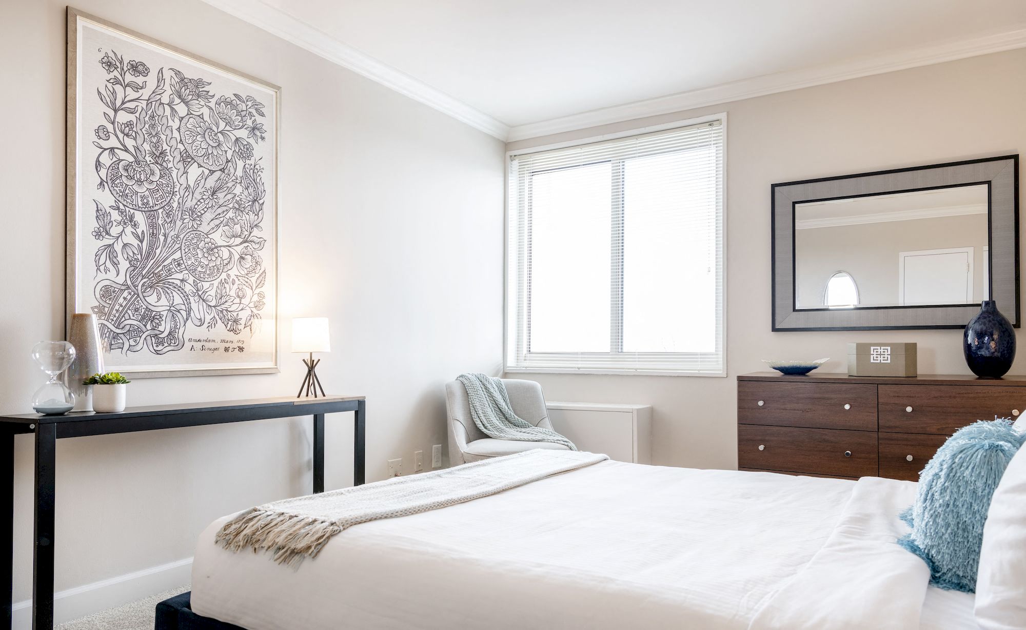 a bedroom with a bed and a dresser and a mirror