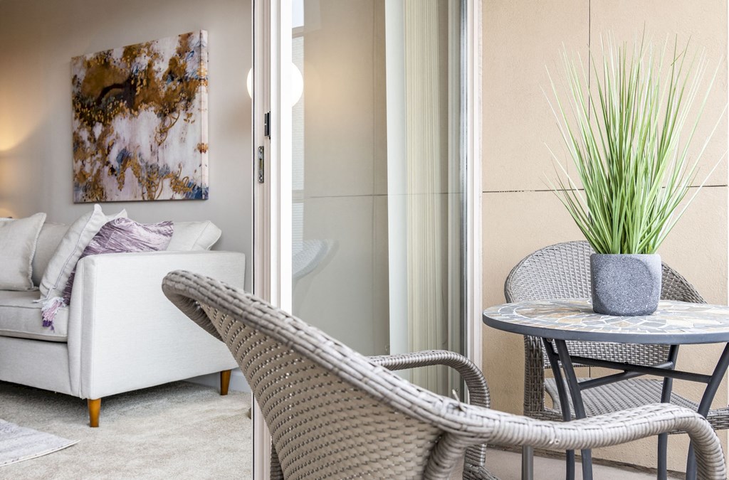 a living room with a couch and a table with two chairs