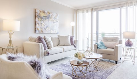 a living room with a couch and chairs and a table