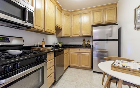 a kitchen with stainless steel appliances and wooden cabinets