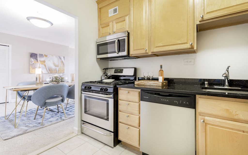 a kitchen with a stove top oven and a sink