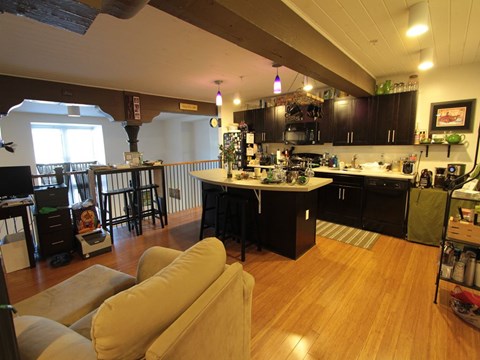 A kitchen with a table and chairs.