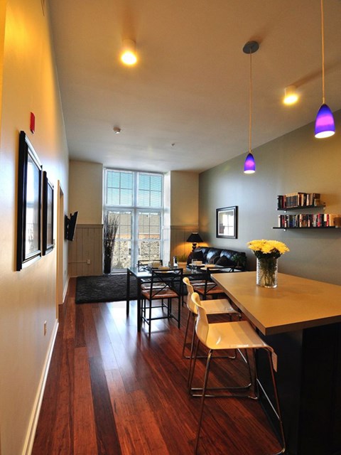 A living room with a long wooden table and chairs.