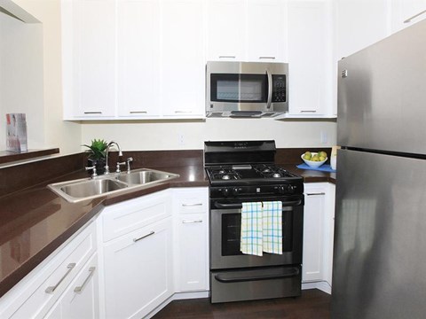 a kitchen with stainless steel appliances and white cabinets
