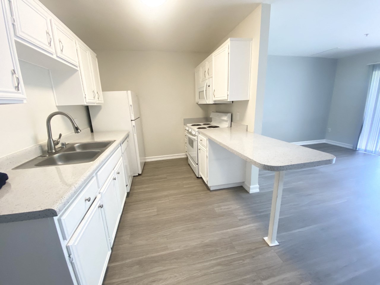 a kitchen with white cabinets and a sink and a counter
