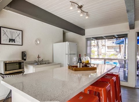the kitchen has a large counter top and a view of the street