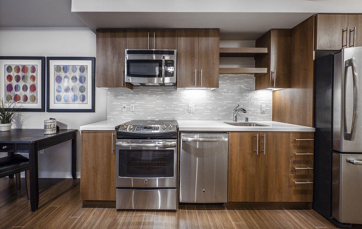 a kitchen with stainless steel appliances and wooden cabinets