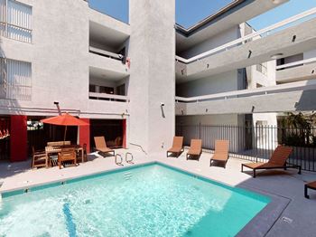 Large Swimming Pool Surrounded with Layout Chairs at City Park View Apartments