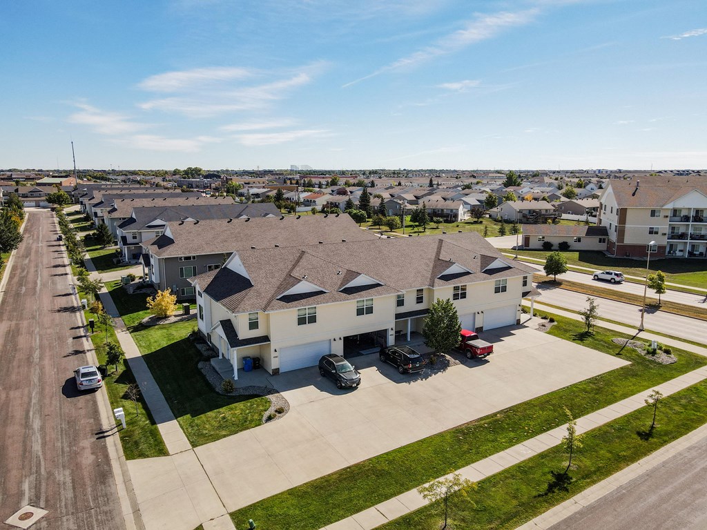 an aerial view of a row of houses in a parking lot