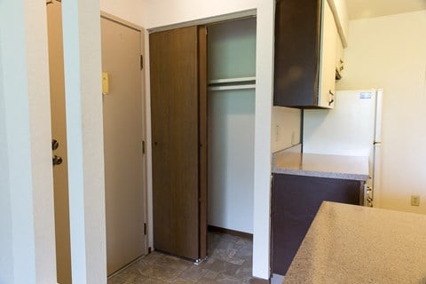 a kitchen with a refrigerator and a door to a closet