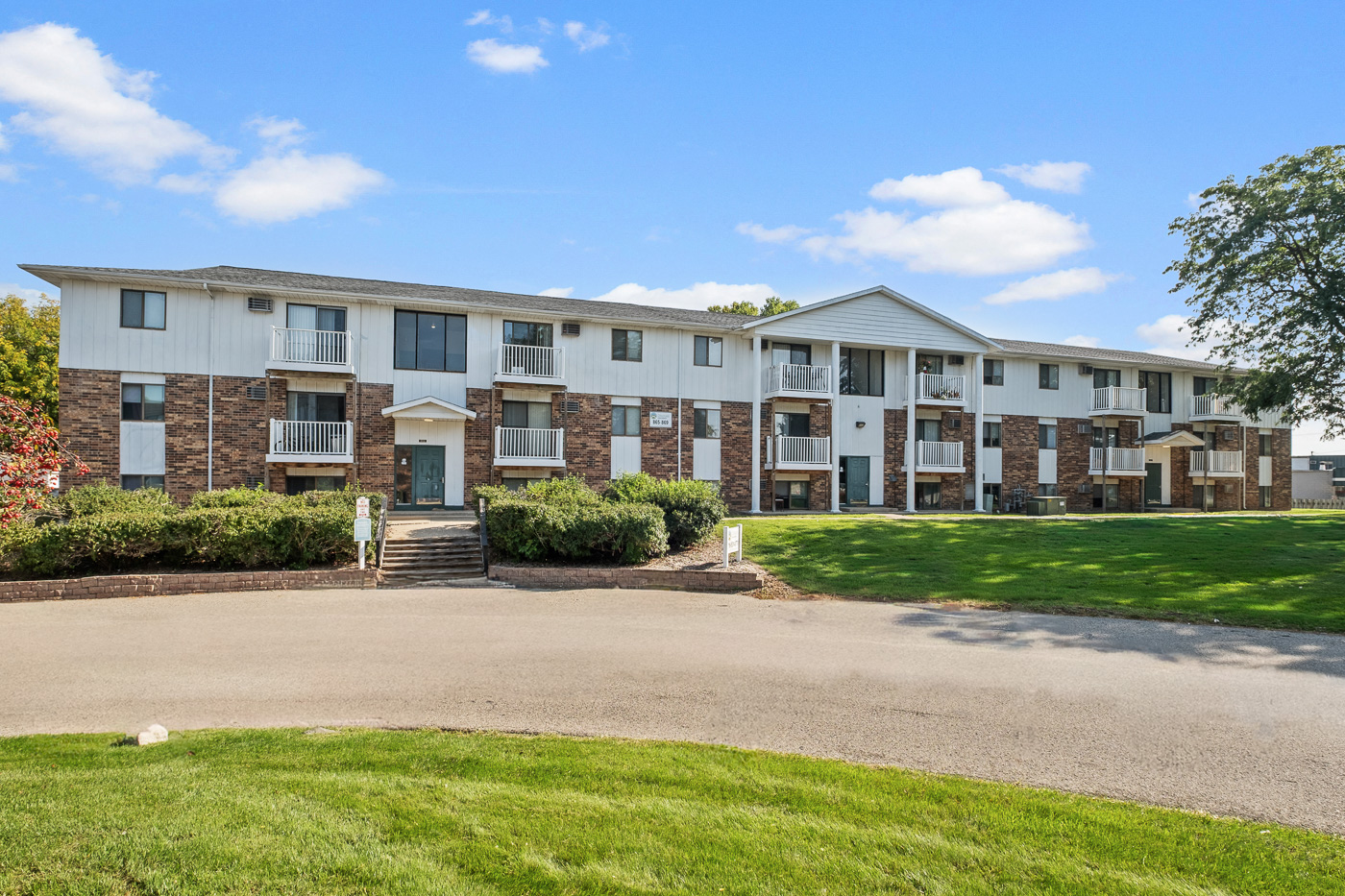 Apartment building with a green lawn in front.