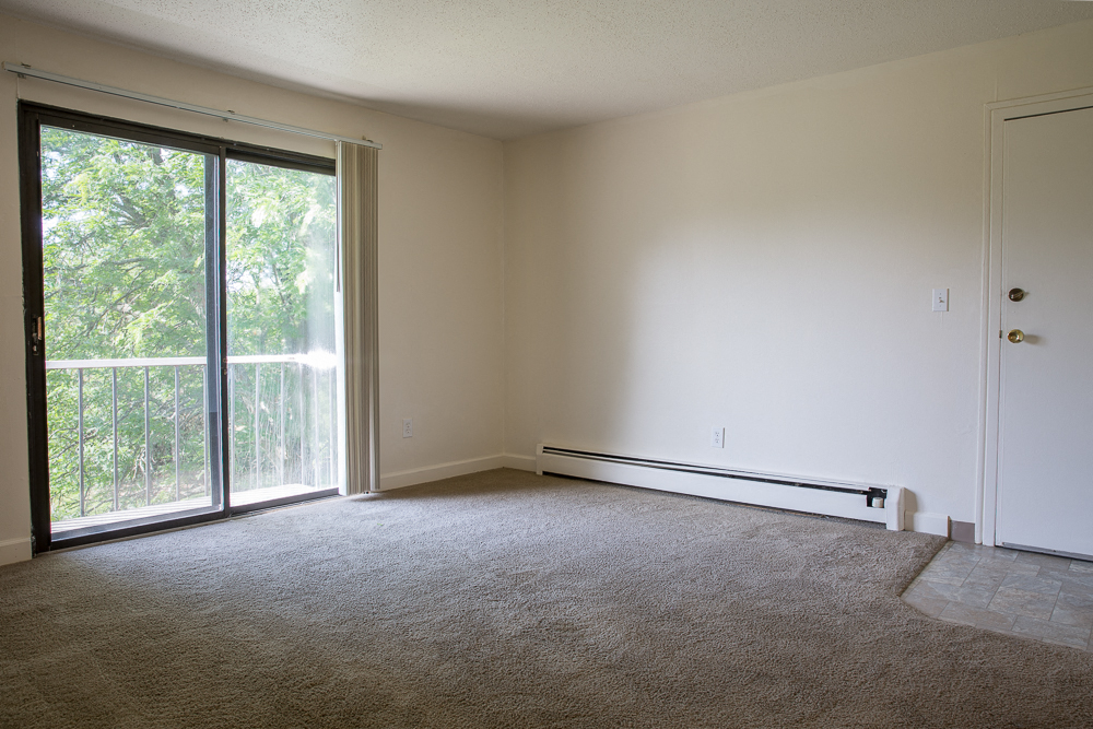 an empty living room with a sliding glass door