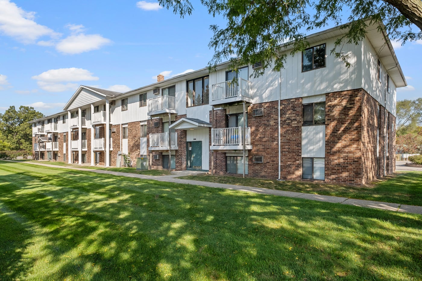 A large apartment complex with multiple balconies and doors.