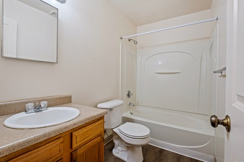 A white toilet sits next to a sink in a bathroom.