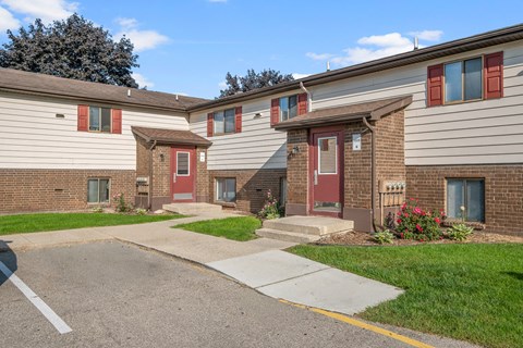 A row of houses with red doors and windows.
