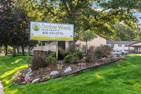 A Dunbar Woods Apartments sign is displayed in front of a well-kept lawn.