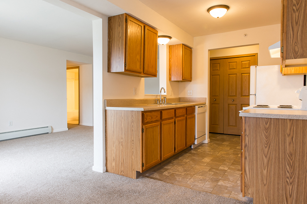 a kitchen with wooden cabinets and a counter top in a house