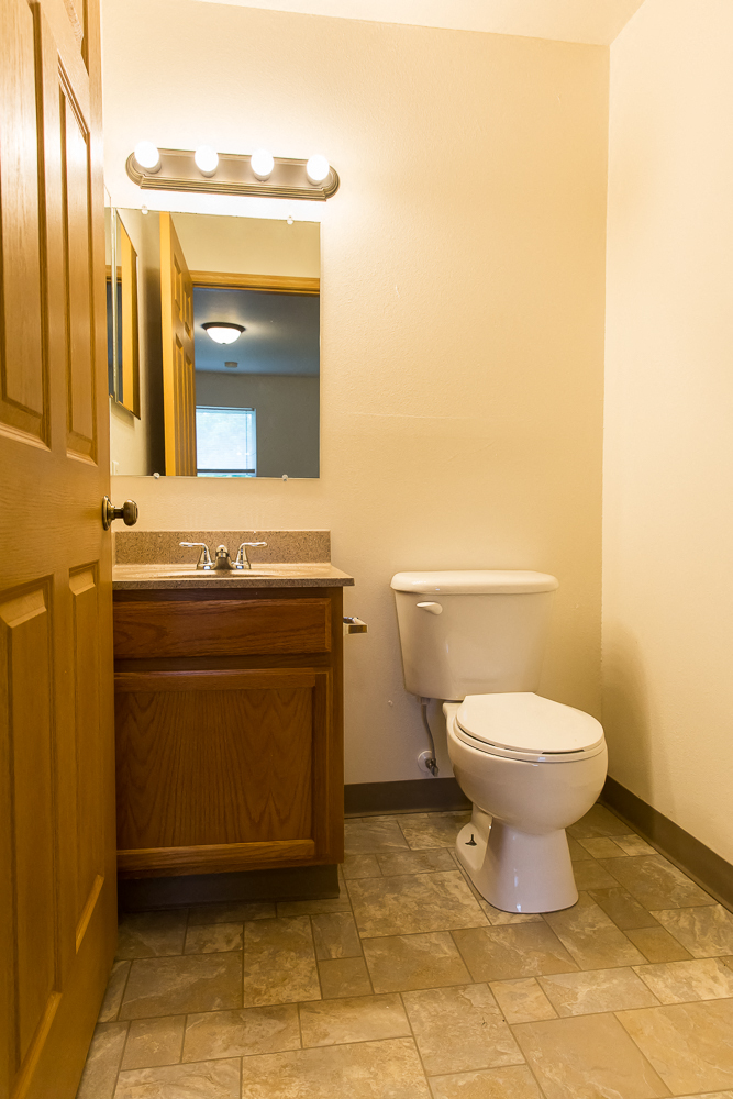a bathroom with a toilet and a sink and a mirror