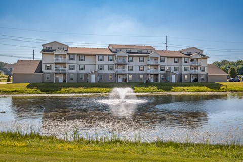 A large building with a fountain in front of it.