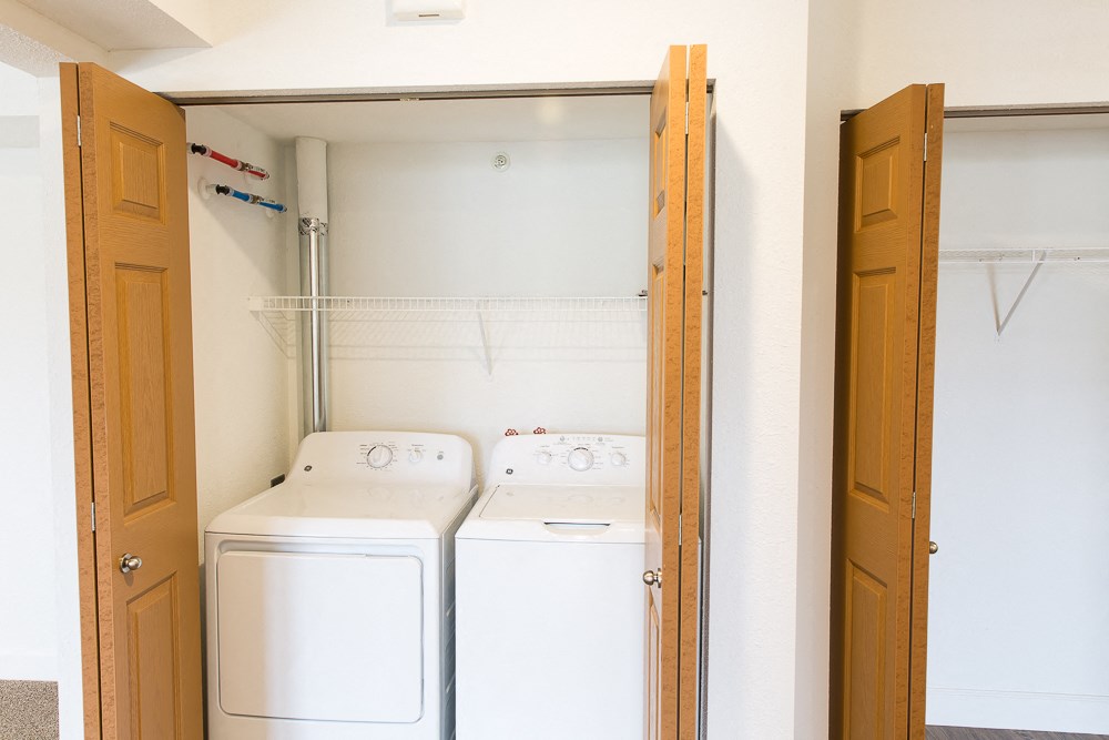 a laundry room with two washes and a dryer