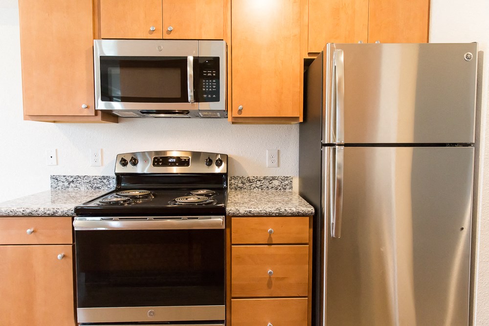 a kitchen with stainless steel appliances and wooden cabinets