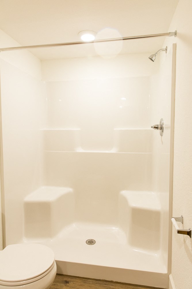 a small bathroom with a shower and a toilet