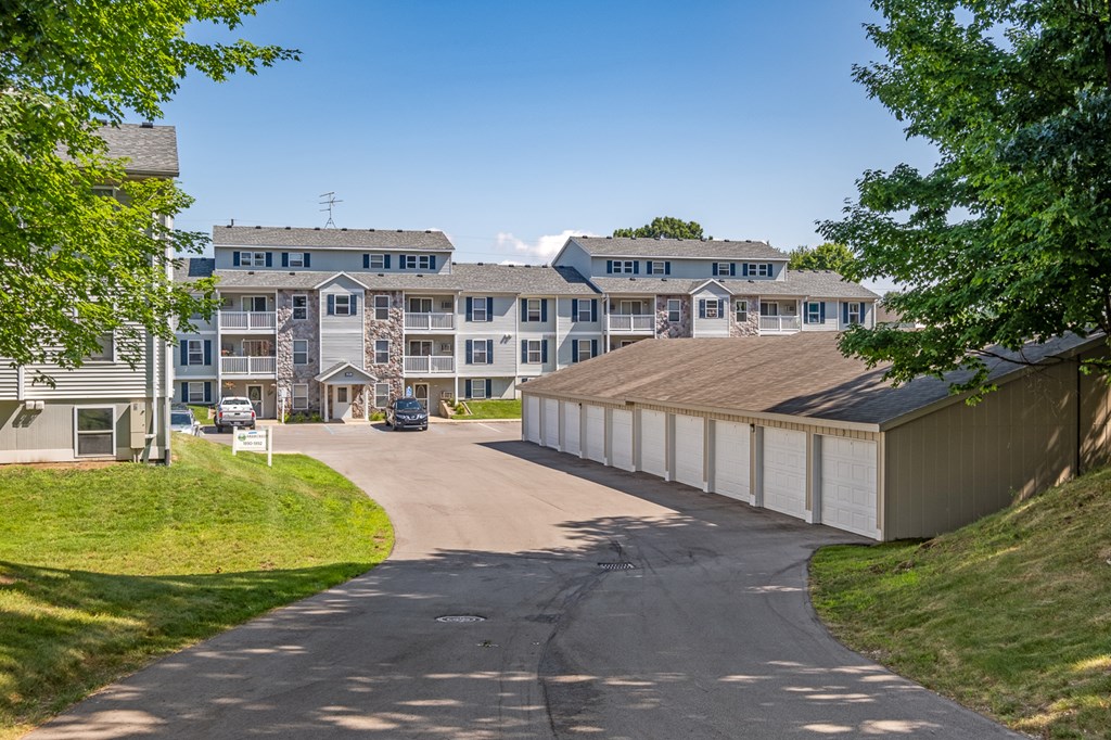 A road leads to a building with a garage door.