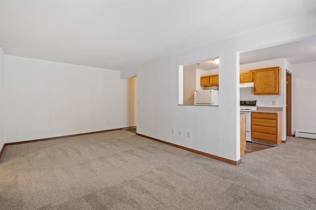 A room with a carpeted floor and a mirror on the wall.