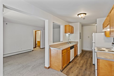 A kitchen with wooden cabinets and a white fridge.
