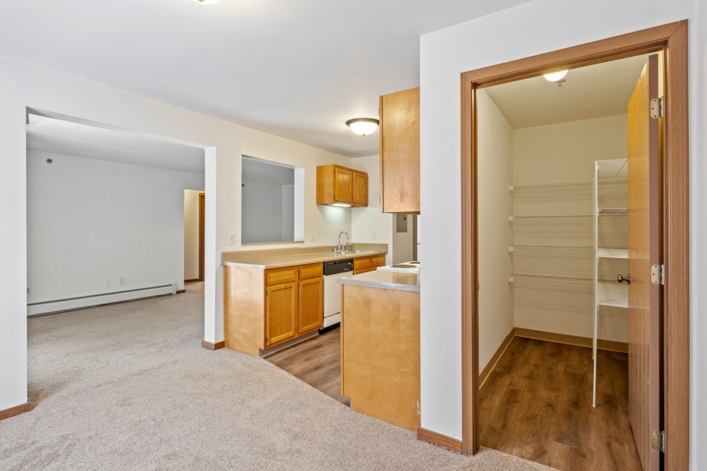 A room with a white wall and a brown door.