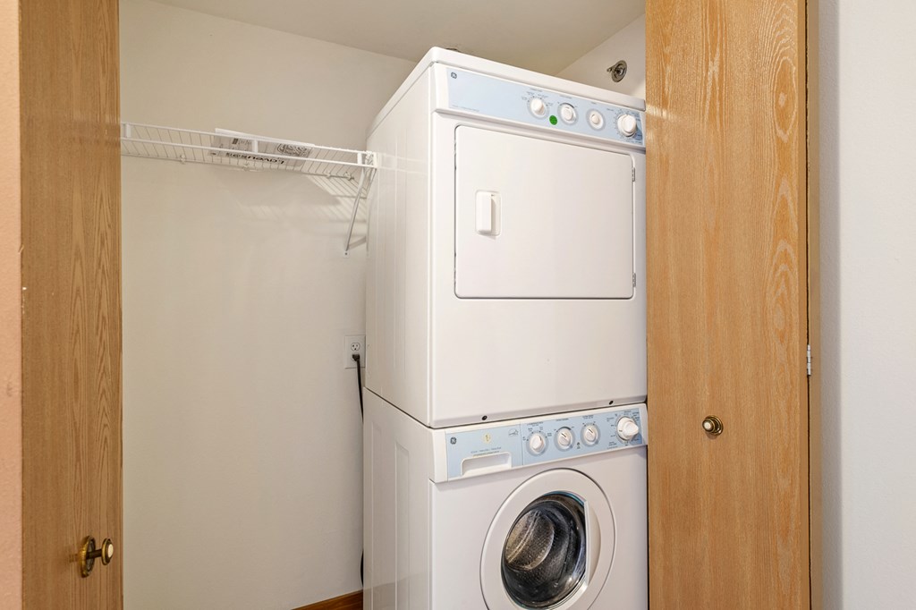 A white washing machine and dryer in a small laundry room.