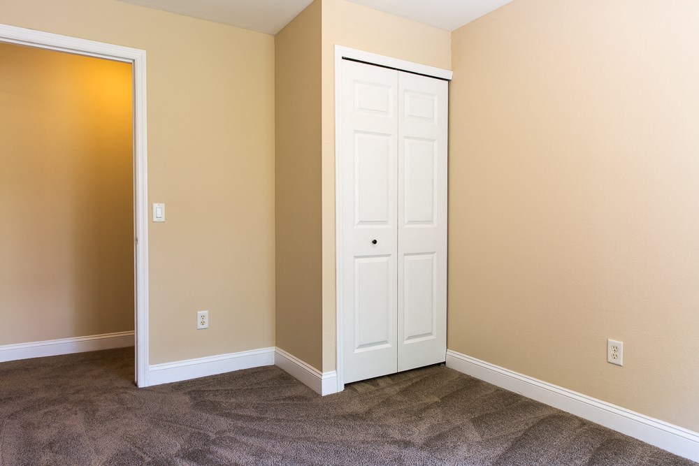 a empty room with a closet and a door