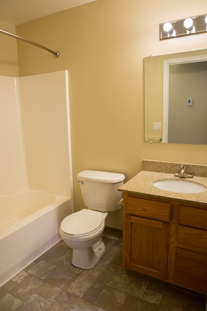 a bathroom with a toilet and a sink and a bath tub