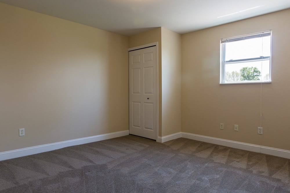 an empty room with a door and a window