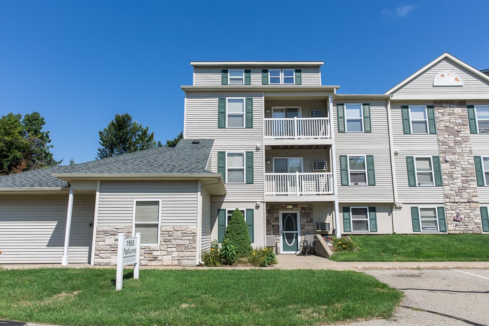 a large house with a yard in front of it
